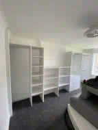 White wardrobe with a mix of hanging, shelving and drawers and also leaving space for a tv, fitted in Redcar